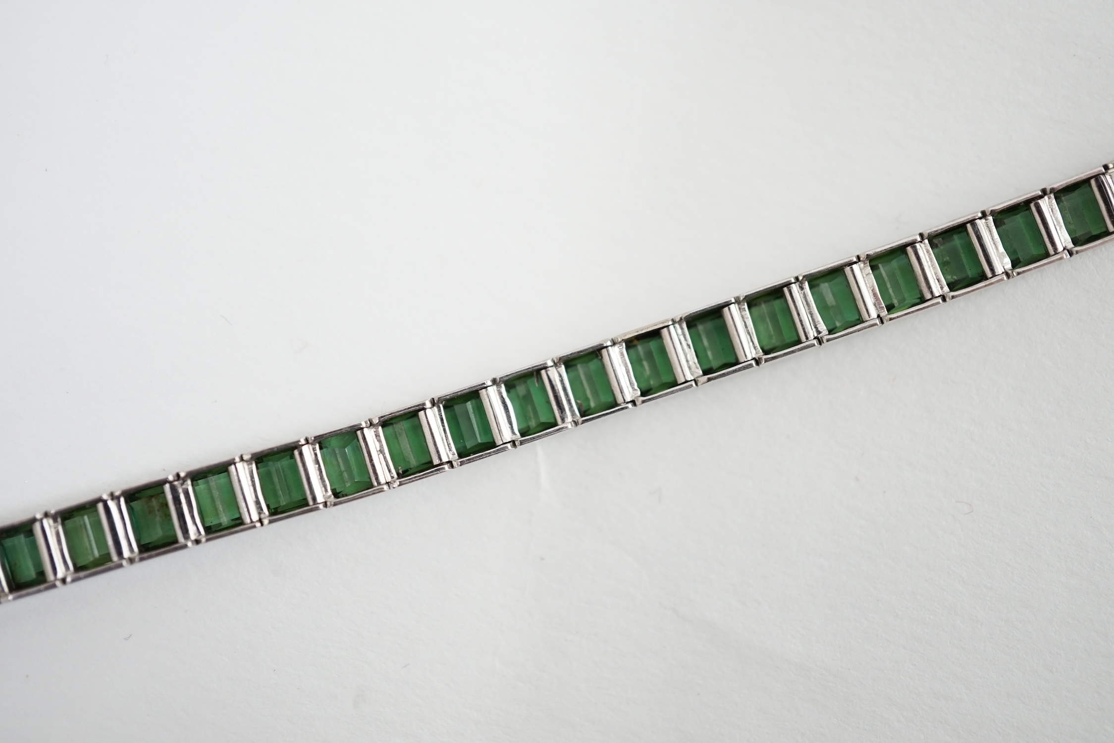 A white gold (tests as 18ct) and green tourmaline line bracelet